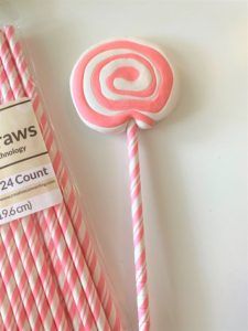 pink and white lollipop candy on a stick