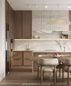 a dining room table and chairs in front of a kitchen with wooden cabinets, counter tops and white lights