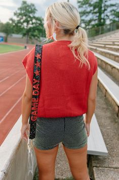 Gear up for game day with this red knit top featuring an embroidered "gameday" design in black. Show off your team spirit for the ULL Rajin' Cajuns with this sleeveless, stretchy top perfect for tailgates and football games. Get ready to cheer your team to victory in style! runs true to size with a roomie fit stretchy model, Kylee is wearing a size small Team Spirit Red Sleeveless Tops, Collegiate Red Sleeveless Top, Red Collegiate Sleeveless Top, Red Sleeveless Tops For College, Red Sleeveless College Tops, Trendy Red Top For Game Day, Trendy Red Tops For Game Day, Sports Fan Sleeveless Tops For Game Day, Sleeveless Sports Fan Tops For Game Day