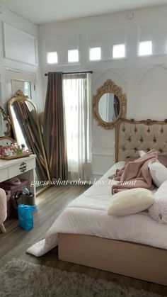 a bedroom with a bed, dressing table and mirror in the corner on the wall