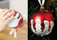 two pictures one is red and the other has white snowmen on it, hanging from a christmas tree