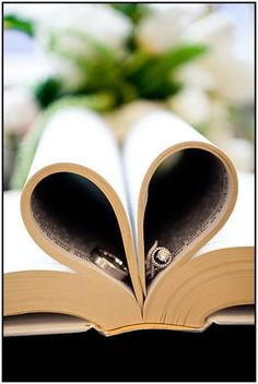 an open book with two pages in the shape of a heart