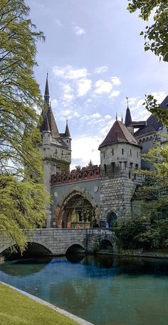 an old castle is next to a river