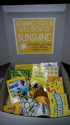 a box filled with lots of different types of food and snacks in front of a sign that says sending you a little boy of sunshine