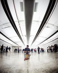 a group of people standing in a large room