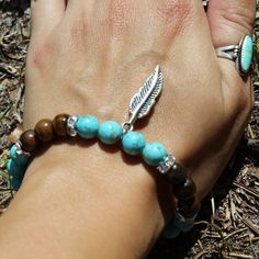 Tigers Eye & Turquoise Feather Bracelet Spiritual Turquoise Beaded Hypoallergenic Bracelet, Hypoallergenic Turquoise Beaded Bracelets For Healing, Spiritual Turquoise Bracelets For Healing, Spiritual Howlite Beaded Bracelets, Turquoise Natural Stones Stretch Bracelet For Healing, Turquoise Stretch Bracelet With Natural Stones For Healing, Turquoise Stretch Bracelet For Healing With Natural Stones, Turquoise Spiritual Bracelets For Friendship, Spiritual Turquoise Stretch Bracelet