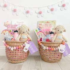 two teddy bears are sitting in baskets with tags on the handles, and decorations around them