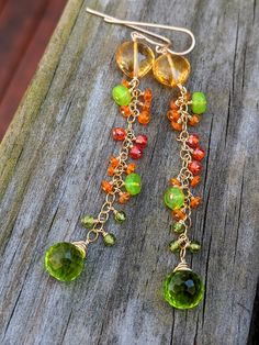 Finely faceted citrine hearts are wrapped above colorful green and orange opals with sparkly orange zircon and rich green vesuvianite. They are finished with spring green hydro quartz onions for a long, elegant look. They measure 3.25" from the top of the ear wire. Wrapped in gold filled wire. Bohemian Green Earrings With Gemstone Accents, Green Citrine Jewelry With Gemstone Accents, Green Citrine Jewelry With Natural Stones, Handmade Green Citrine Jewelry, Green Multi-stone Dangle Jewelry, Cluster Jewelry, Lavender Quartz, Spring Wildflowers, Bold Jewelry