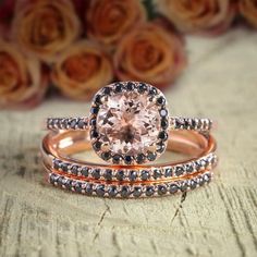 two rose gold wedding rings with an oval morganite surrounded by black and white diamonds