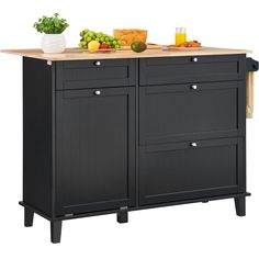 a kitchen island with drawers and cutting board on it's side, next to a bowl of fruit