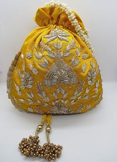 Festive Gold Embroidery Potli Bag, Festive Potli Bag With Gold Embroidery, Festive Gold Embroidered Potli Bag, Traditional Gold Embroidered Potli Bag For Festivals, Traditional Potli Bag With Gold Embroidery For Festivals, Festive Gold Potli Bag With Gold Embroidery, Traditional Gold Embroidered Potli Pouch Bag, Traditional Resham Embroidery Potli Bag For Festive Season, Bollywood Resham Embroidery Potli Bag For Diwali