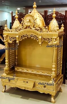 an ornately decorated golden bench in a store