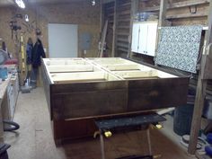 a workbench in a garage with lots of drawers and tools on the floor