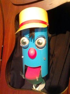 a close up of a blue toy with a hat on it's head and mouth