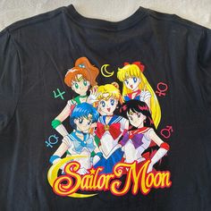 Brand New Never Worn Black Sailor Moon Shirt (Whole Group On The Back) Symbols On The Front Fits Like A Medium But Is A Large Cute Black Crew Neck Shirt, Black Fandom Tops With Screen Print, Black Short Sleeve Fandom Top, Retro Black Top With Anime Print, Black Retro Top With Anime Print, Retro Black Anime Print Tops, Black Retro Anime Print Top, Black Fandom Top With Front Print, Cute Black Anime Print Tops