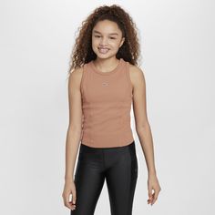 Whether you're zooming through dance tutorials or a busy weekend, this soft and stretchy ribbed crop top pulls sweat away from your body to help you comfortably move through whatever your day holds. So go ahead and perfect that viral dance step. This is your time to shine. Spring Sports Ribbed Tops, Ribbed Sports Tops For Spring, Nike Stretch Crop Top For Sports, Nike Stretch Sports Crop Top, Nike Stretch Crop Top For Workout, Stretch Nike Tops For Gym, Nike Stretch Tops For Gym, Nike Stretch Activewear For Spring, Stretch Nike Gym Tops