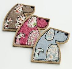 three embroidered patches with dogs on them, one is pink and the other is blue