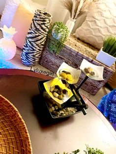 a table topped with plates and bowls filled with food on top of each other next to decorative vases