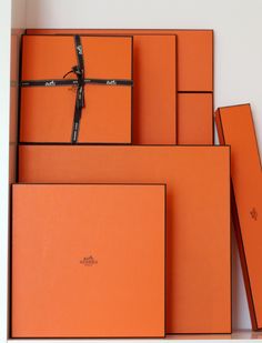 several orange boxes stacked on top of each other