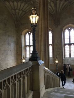 people are walking up and down the stairs in an old building