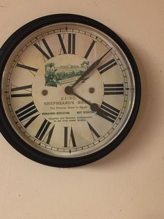 a clock on the wall with an old advertisement