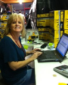 a woman sitting in front of a laptop computer