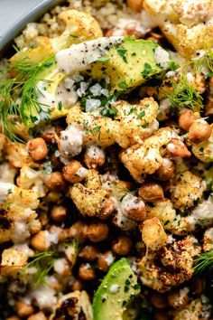 a bowl filled with cauliflower, chickpeas and avocado salad