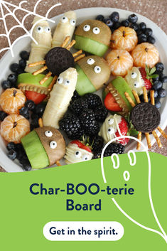 a bowl filled with fruit and veggies covered in googly eyes for the word char - boo - terie board