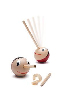 two wooden toys with faces and sticks sticking out of them