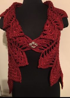 a red knitted shawl on a mannequin