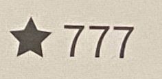 the number 777 with a star on it is shown in black and white ink