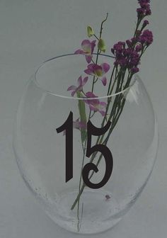 there is a vase with flowers in it and the number thirteen on the front side