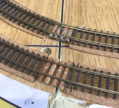 a train track laying on top of a wooden floor