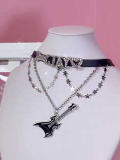 Elevate your accessory game with this chic Rhinestoned Letters Y2K Stars Guitar Pendant Black PU Choker. This statement piece features a sleek black PU leather band that comfortably wraps around your neck. The choker is adorned with dazzling rhinestoned letters that spell out a retro Y2K vibe, making it a perfect addition for anyone looking to embrace early 2000s fashion. The standout guitar pendant, embellished with tiny stars, adds a touch of rockstar glam. Black Rock Jewelry, Rockstar Glam, Y2k Stars, Guitar Pendant, Steampunk Fashion Female, Steampunk Fashion Male, Gothic Skirts, Early 2000s Fashion, Steampunk Accessories