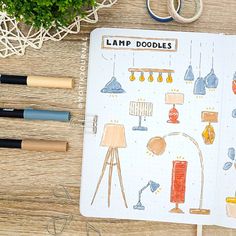 an open notebook sitting on top of a wooden table next to scissors and other items