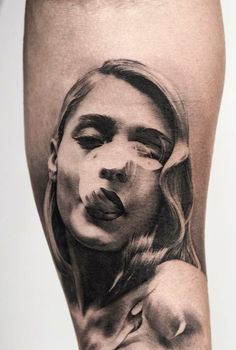 a woman's leg with a black and white photo on it, in the shape of a tattoo