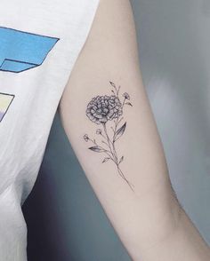 a woman's arm with a flower tattoo on the left side of her arm