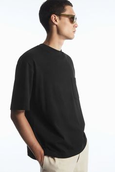 The Heavy Duty T-shirt is a few steps up from your classic jersey tee. Weighing in at a substantial 290gsm, it's made with CIRCULOSE® and premium organic cotton that's hefty, warm and holds the boxy shape in place. It's designed with a mock neck, dropped shoulders and a casual patch pocket at the chest – perfect for hooking your sunglasses onto. Oversized fit, 290gsmSide slits, stepped hemFeaturing viscose partly made with CIRCULOSE®, a pulp made from 100% recycled textile waste  Shell: 70% Orga Organic Cotton Boxy Fit T-shirt With Crew Neck, Modern Boxy Fit Cotton T-shirt, Essential Relaxed Fit Cotton T-shirt, Modern Boxy Fit T-shirt For Everyday, Cotton T-shirt For Streetwear, Essential Cotton T-shirt For Streetwear, Basic Boxy Fit T-shirt In Organic Cotton, Genetically Modified, Knitted Tshirt