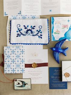 the wedding stationery is laid out on top of each other, including cards and envelopes