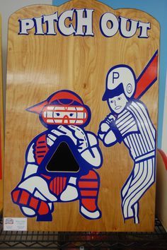 a wooden sign that says pitch out and a baseball player holding a bat in front of him