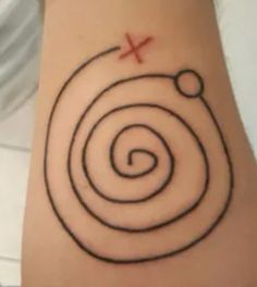 a tattoo with a spiral design on the side of its arm and an x in the middle