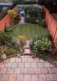 an aerial view of a backyard garden with brick pavers