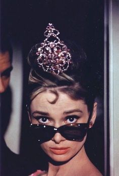 a woman with sunglasses and a tiara on her head