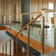 the inside of a house with wood and metal railings