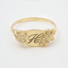 This vintage-inspired floral ring is a series of dainty flowers wrapped around your fingers. Handmade and polished, it is available in 14K gold.This item is engravable with text or monogram of your choice at no extra cost. The initals are engraved onto the ring and embedded in the 3D model for a flawless embossed finish. You may also request for writing on the inside!You may choose to customize this ring with different flowers or letters. Depending on the text used, the flowers may be rearranged Elegant Engraved Gold Signet Ring, Vintage Engraved Yellow Gold Signet Ring, Floral Engraved Gold Signet Ring, Victorian Gold Signet Ring Gift, Victorian Yellow Gold Signet Ring With Initials, Printable Ring Sizer, How To Wrap Flowers, Gold Monogram, Ring Vintage