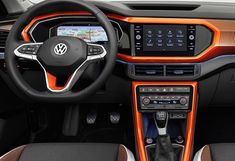 the interior of a car with orange trim