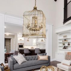 a chandelier hanging from the ceiling in a living room