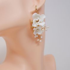 New to our Millennium Bride Collection These Beautiful Romantic CERAMIC WHITE FLORAL Fresh water Pearls BRIDAL EARRINGS beautifully made Fresh water pearls and ceramic flowers for your special day! Freshwater pearls are real, cultured pearls, grown in lakes, rivers, as well as ponds. Most Freshwater pearls are white and resemble Akoya pearls, but they also produce a variety of pastel shades, including pink, lilac and peach. Even we have hard time taking pictures because of their shine 😄 so we w Delicate White Teardrop Flower Earrings, White Teardrop Flower Earrings For Wedding, White Teardrop Bridal Earrings For Pierced Ears, Delicate White Teardrop Chandelier Earrings, White Teardrop Flower Earrings For Anniversary, Delicate White Pearl Earrings, Delicate White Chandelier Drop Earrings, White Drop Earrings With Handmade Flowers, Elegant White Teardrop Flower Earrings