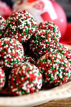 there are many red and green sprinkles on this cake ball that is ready to be eaten