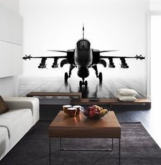 a black and white photo of an airplane on the wall in a living room with two couches